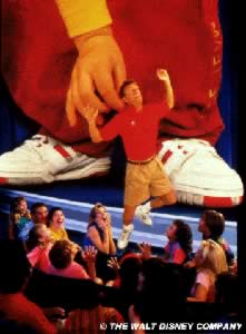 Promotional shot showing Adam picking up an audience member - not an actual scene from the attraction